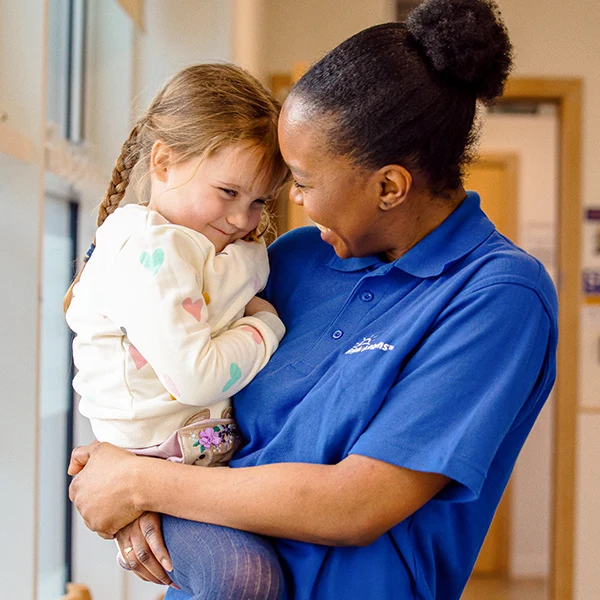 Bright Horizons nursery practitioner sharing a warm moment with a child