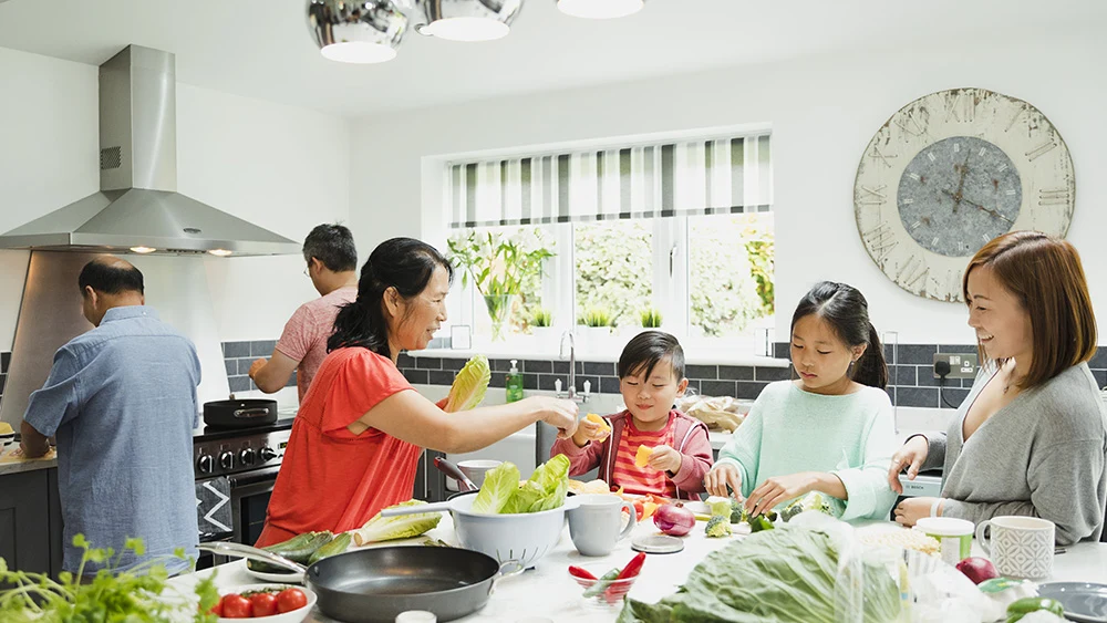 Family preparing a meal together with Groupe SEB kitchen products