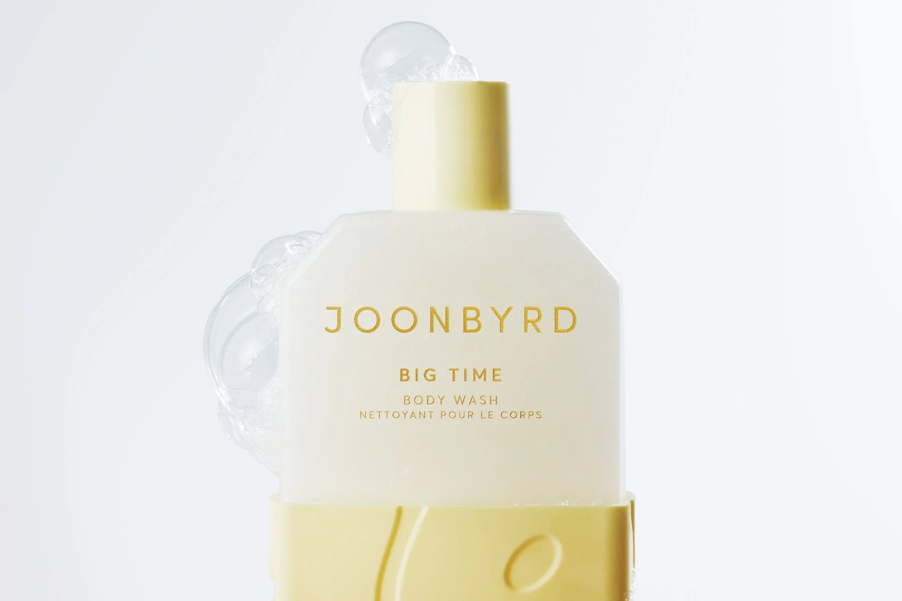 Joonbyrd Big Time body wash with sculptural bubbles against a pale blue background