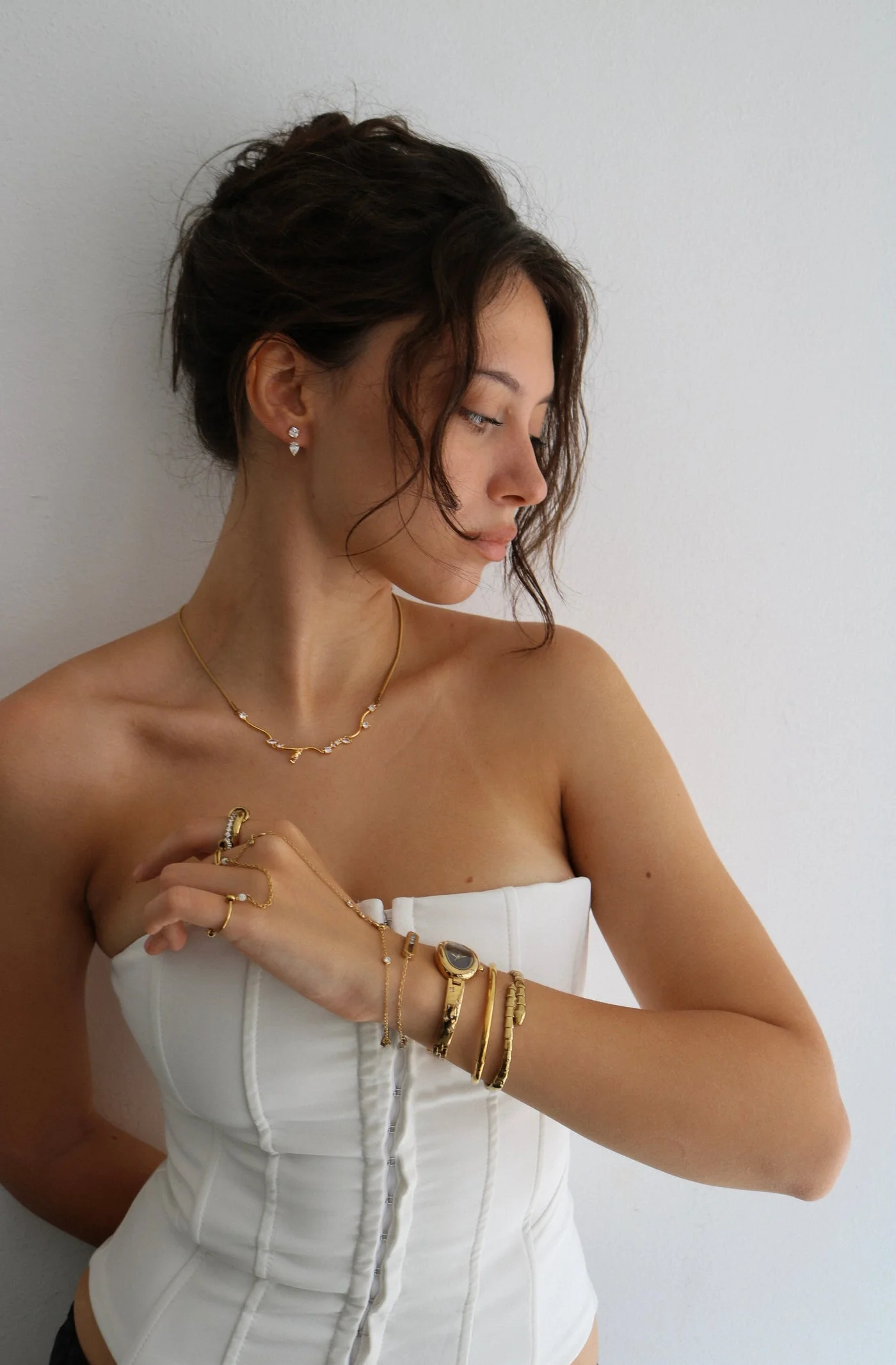 Model wearing Regina Jewelry necklaces, earrings, rings, and bracelets